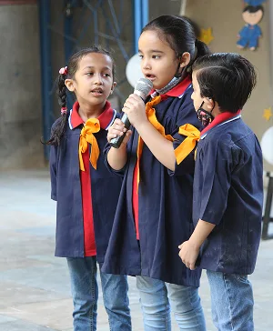 Young Student Speaking into Microphone During School Event Activity