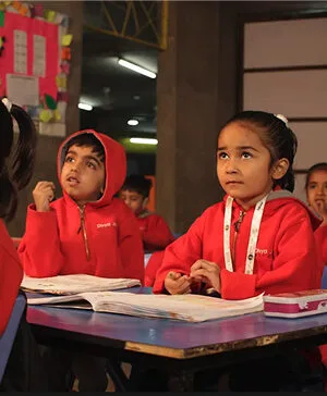 Young Students Attending Classroom Lesson in Winter Uniforms